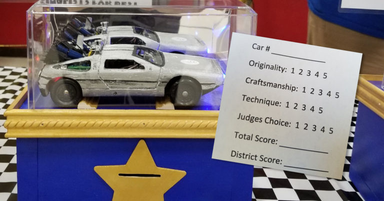 Volunteers invent an ingenious method of Pinewood Derby car judging
